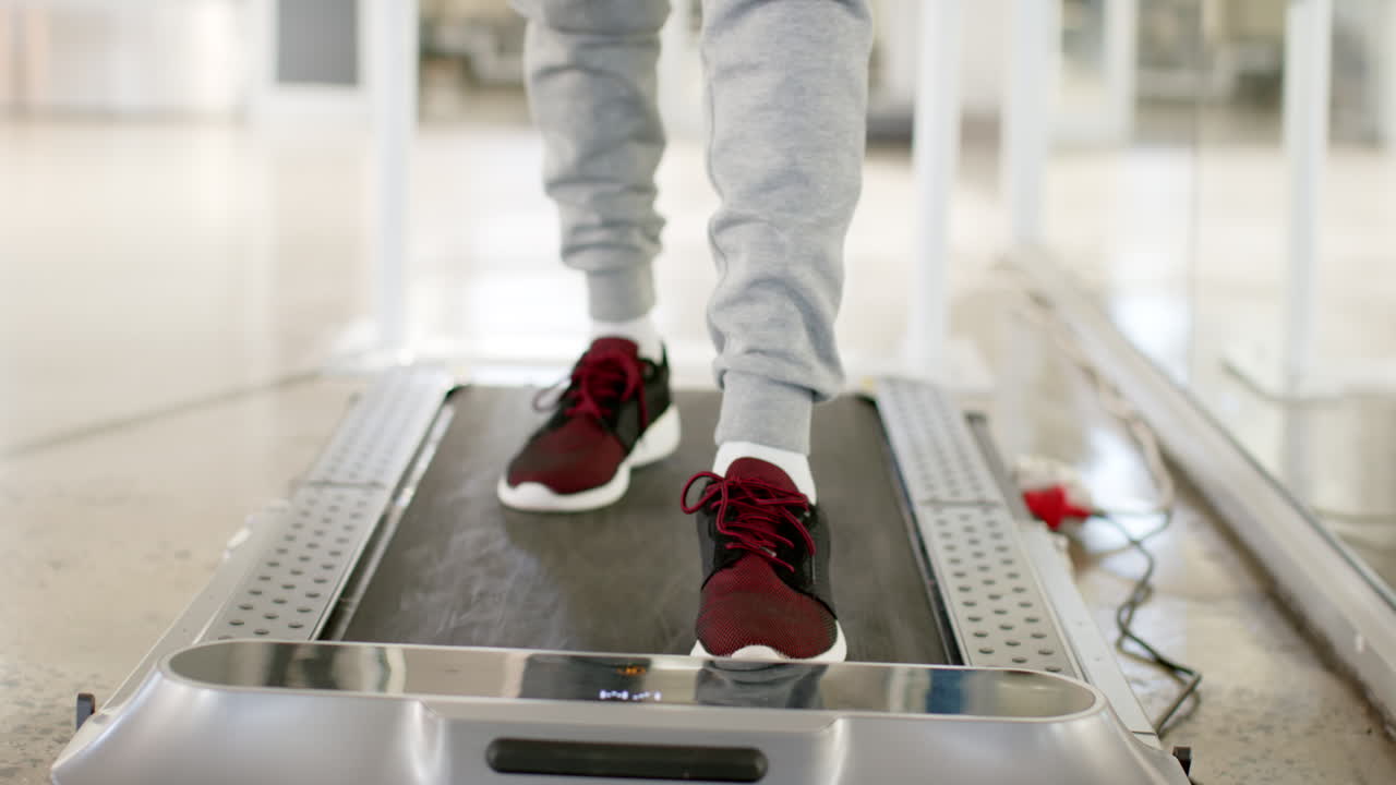 Person walking on treadmill for rehabilitation therapy