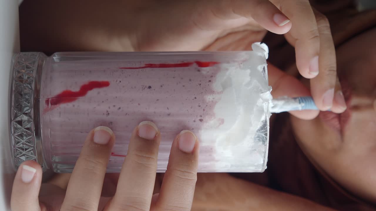 Woman drinking a strawberry smoothie