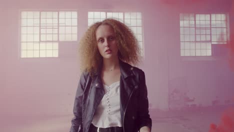 fashionable young woman in an abandoned warehouse