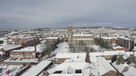 aerial view of st jame's church covered in snow in the midlands, christian, roman catholic religious orthodox building in a mainly muslim area of stoke on trent in staffordshire, city of culture