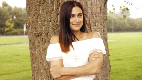 Pretty-brunette-smiling-in-the-park