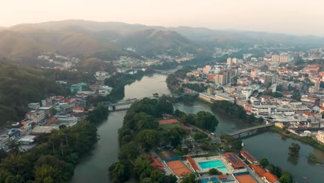 Aerial-View-of-Downtown-Barra-do-Piraí,-Rio-de-Janeiro,-Brazil-over-the-Paraíba-do-Sul-River-at-Dusk