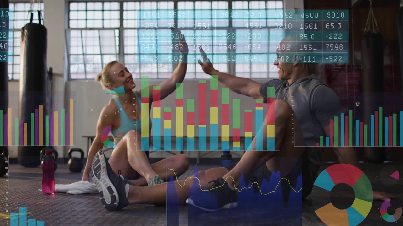 After workout fitness pair sitting on mat, charts shifting over them, high-fiving marking progress