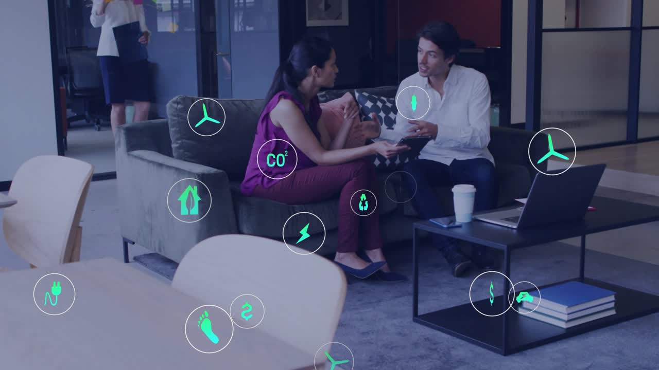 Coworker woman turning tablet, tapping screen, man explaining energy data, eco icons floating