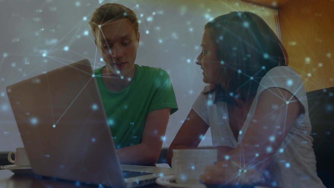 Animation of a couple using a laptop over a web of connection in the background. 