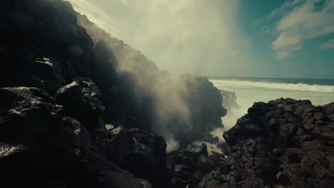 powerful ocean waves crashing against volcanic rocks