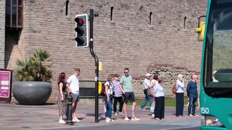 people waiting to cross the road