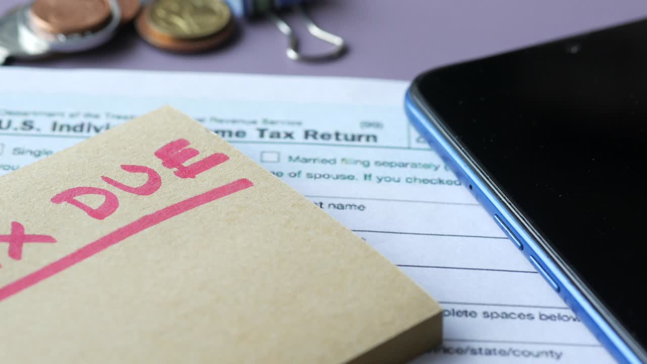 Tax return form and hand written tax due on table