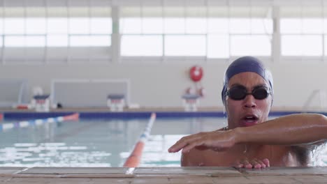 Swimmer-coming-out-of-water-and-looking-at-camera