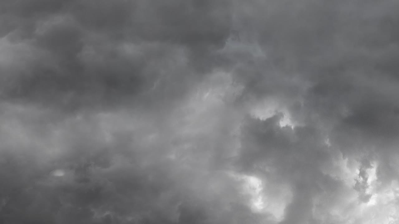 view of dark sky with black clouds and thunderstorm