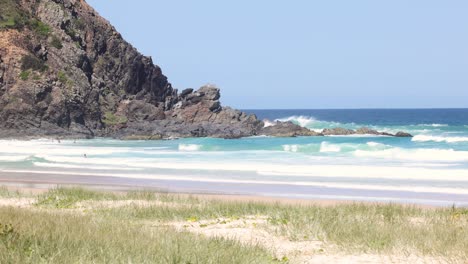 a serene beachscape with waves and visitors