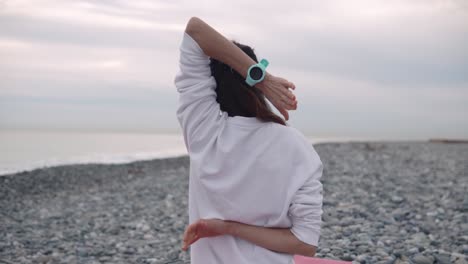 woman stretching on a beach