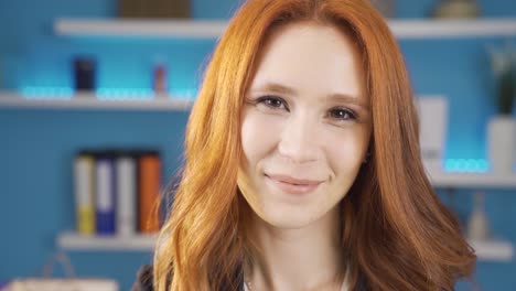 young business woman taking off her glasses in office smiling at camera.