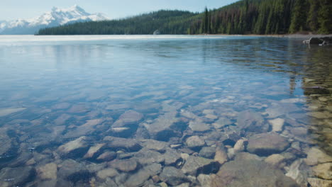 ice covered crystal clear water of mountain lake on a sunny day cu