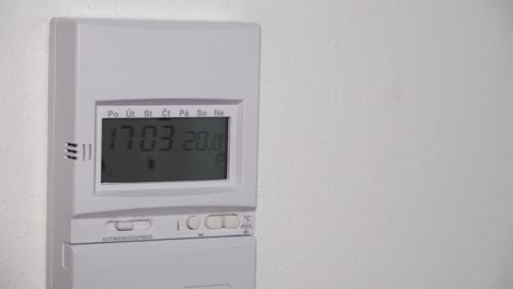 Higher-thermostat-temperature-setting-up,-digital-display-and-hand-closeup-view