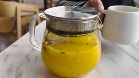 unique and healthy hot lemonade, served steaming with slices of fresh lemon, a touch of honey, and aromatic spices like cinnamon or ginger