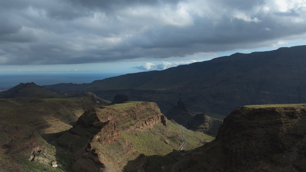Clouds move quickly above a mountain range in Gran canaria, canary islands, spain, in this timelapse video. Ansite fortress.