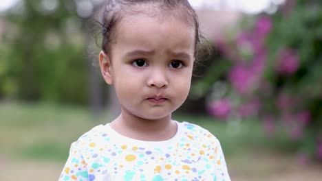 cute toddler standing at outdoor innocent annoying facial expression at evening