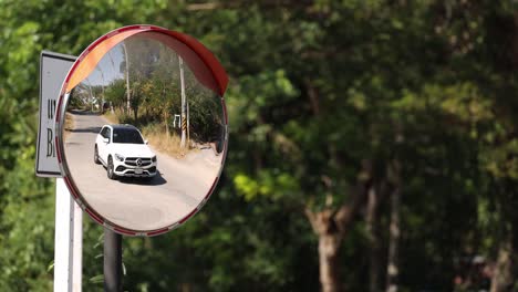 vehicle passing by as seen in a road safety mirror