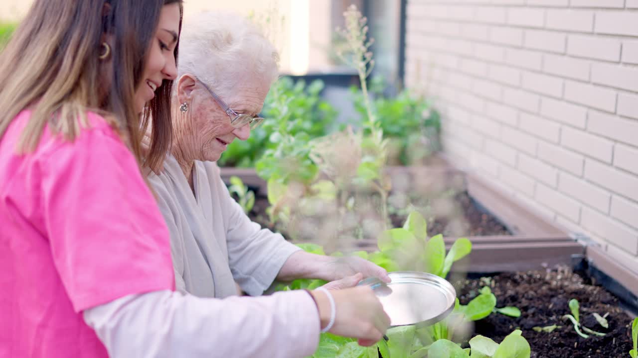 Elderly woman gardening with caretaker
