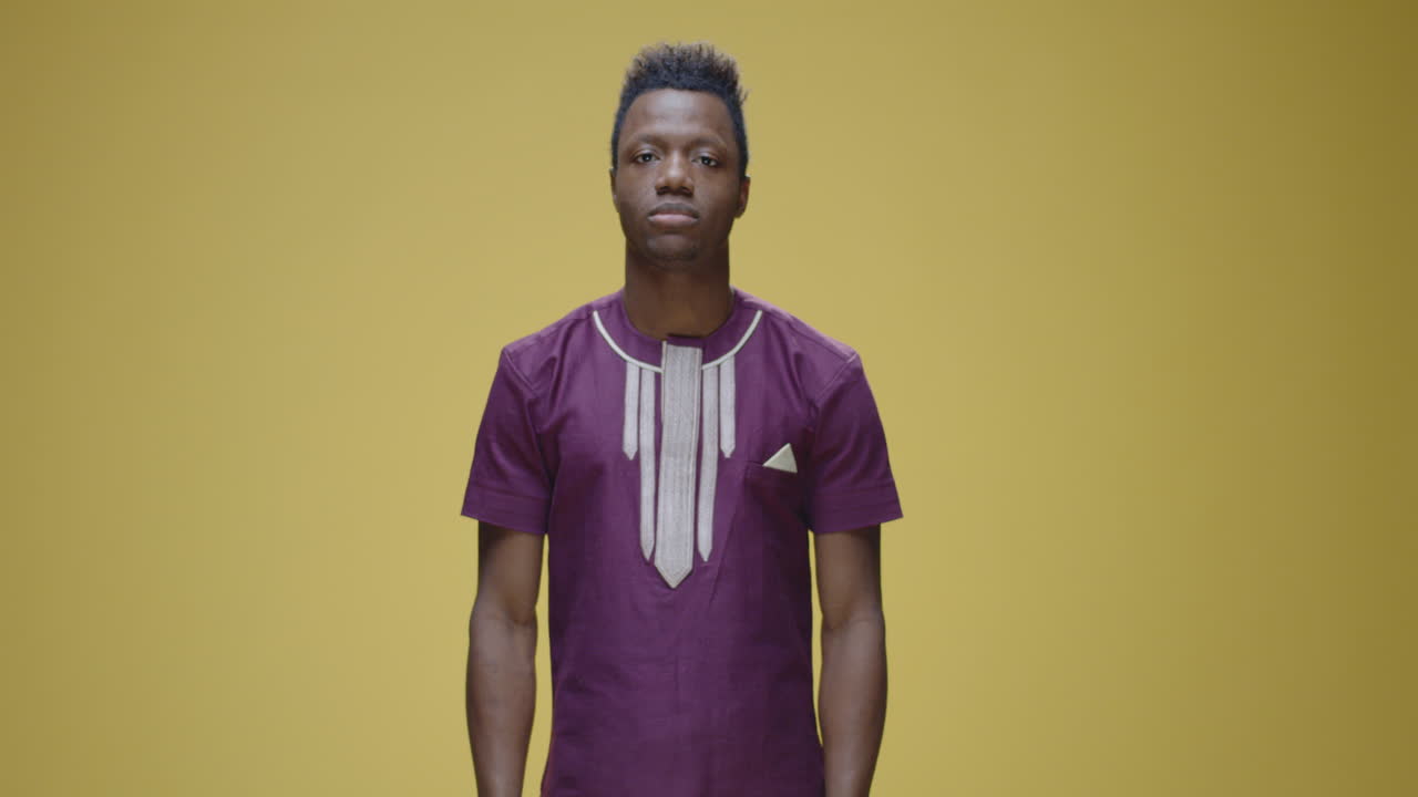 A man reacting to loud noise or discomfort by covering his ears