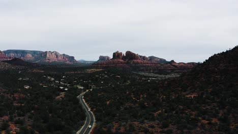 drone shot of cars driving through arizona's desert landscape