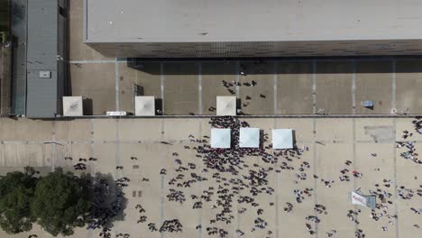 aerial view of a large crowd of people gathering in a city plaza