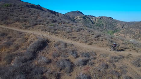 Good-aerial-following-a-mountain-biker-ascending-a-California-mountain-3