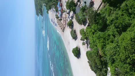 vertical aerial establisher of exotic hotel resort with beautiful straw parasols