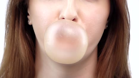 girl blowing a big bubble gum bubble white background slow motion girl blowing a big bubble gum bubble sexy red lips brown hair lipstick white background slow motion