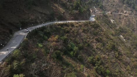 drone follow a car driving on narrowed himalayan road in india himachal pradesh mountains region trekking travel destination