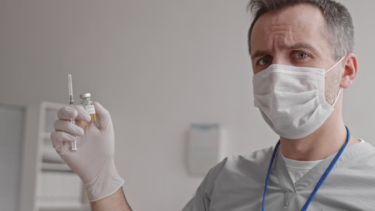 Doctor Holding Ampoule and Syringe