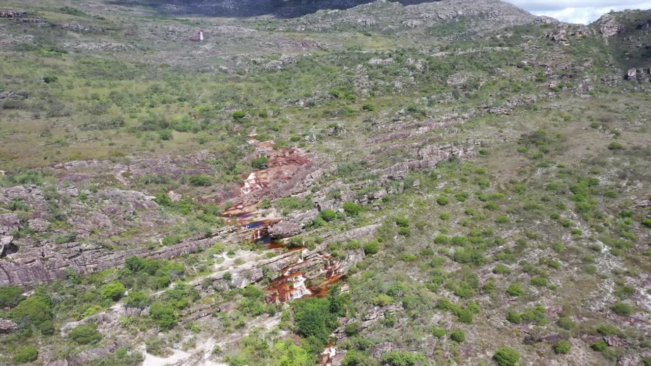 toma aérea de drones de un río rocoso en medio de colinas secas