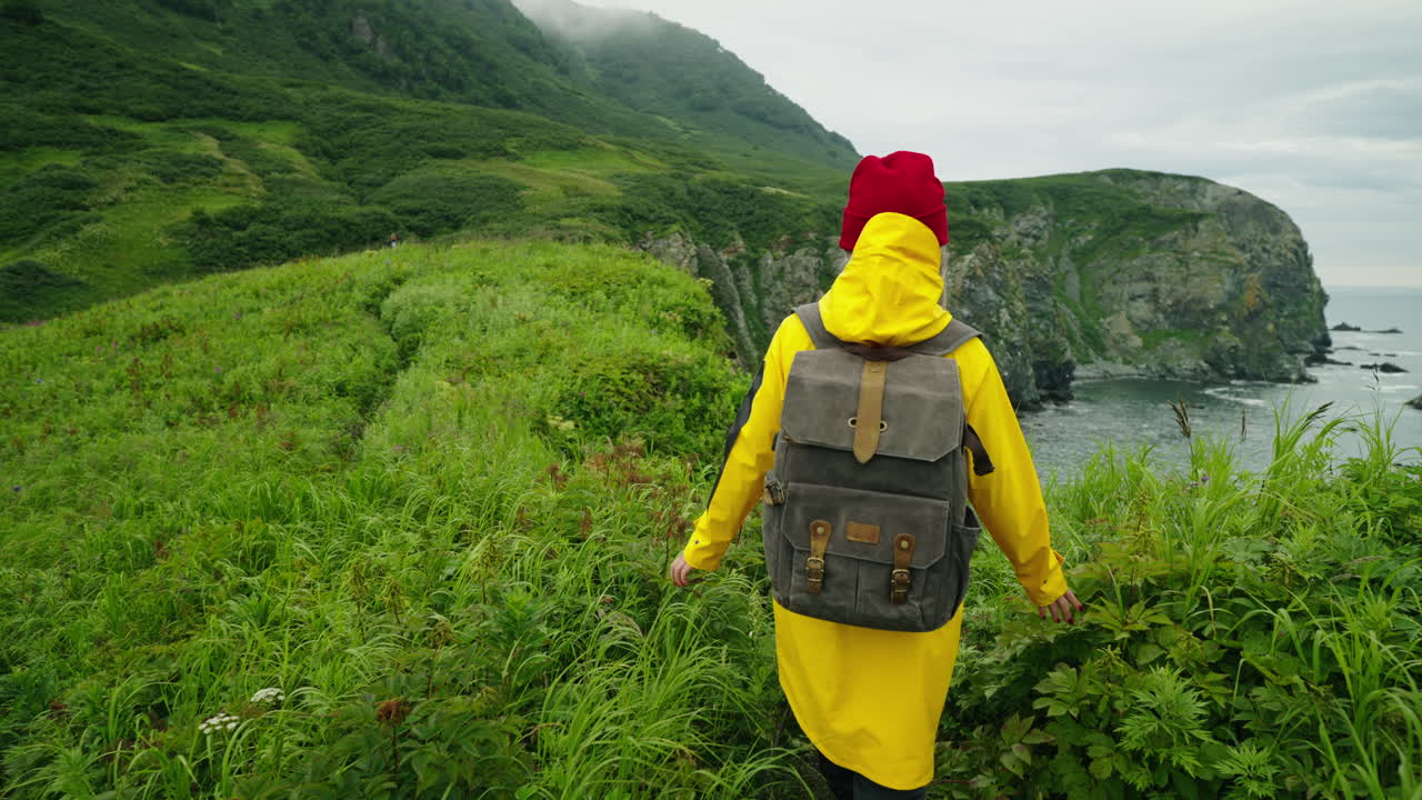 Woman Hiking Along a Rocky Coastline