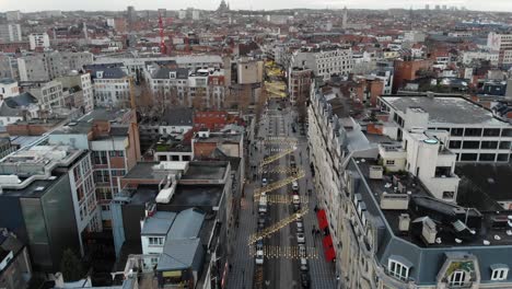 Aerial-upward-flight-over-Brussels-city-on-cloudy-day,-Belgium