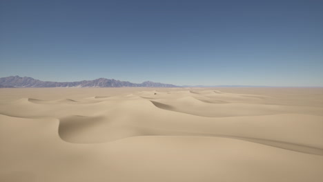 desert landscape with sand dunes and mountains