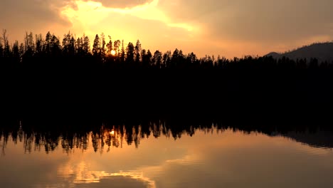 vertical footage of sunset over a lake in the yellowstone national park