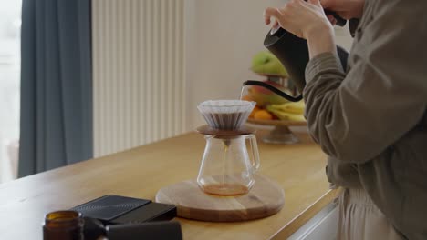 woman pouring coffee using pour over method