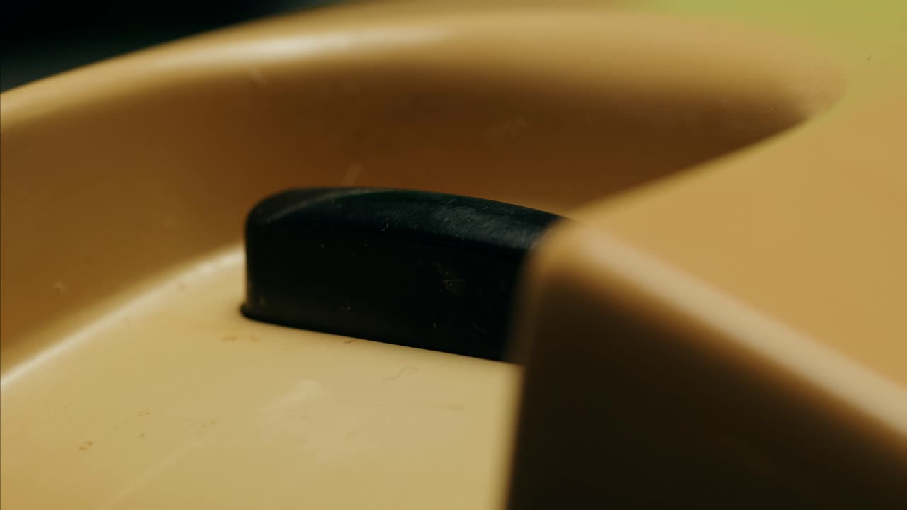 Retro vintage phone, A yellow rotary telephone is displayed on a wooden desk, adding a nostalgic touch