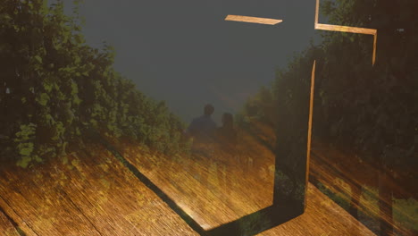 animation of shining lights over crucifix and landscape
