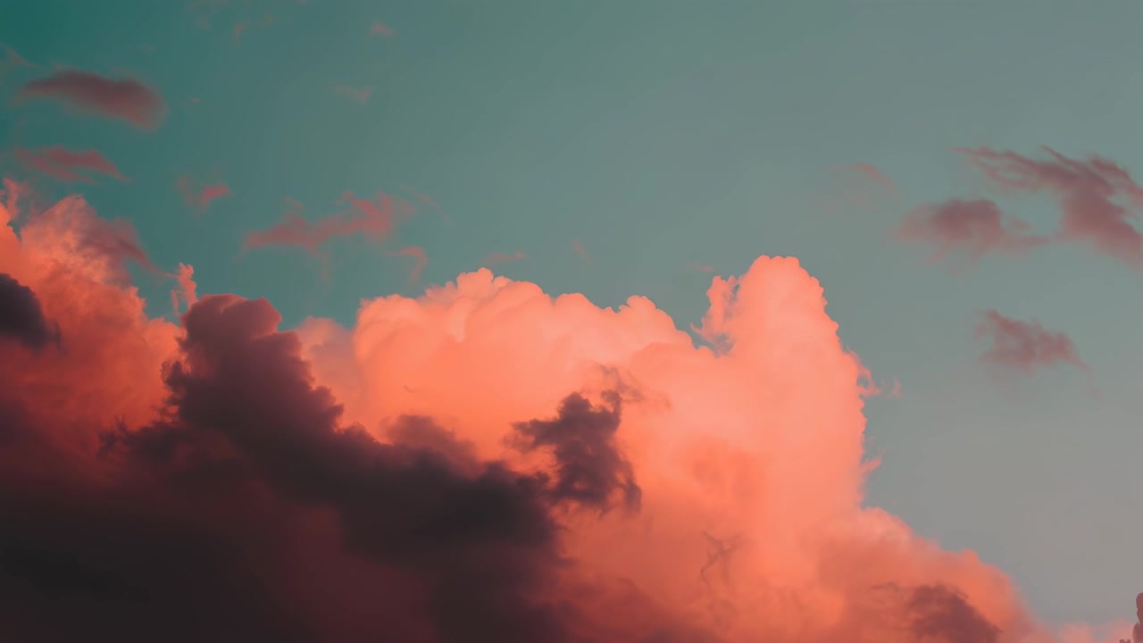 Dramatic Sunset Clouds Drifting Across a Teal Sky