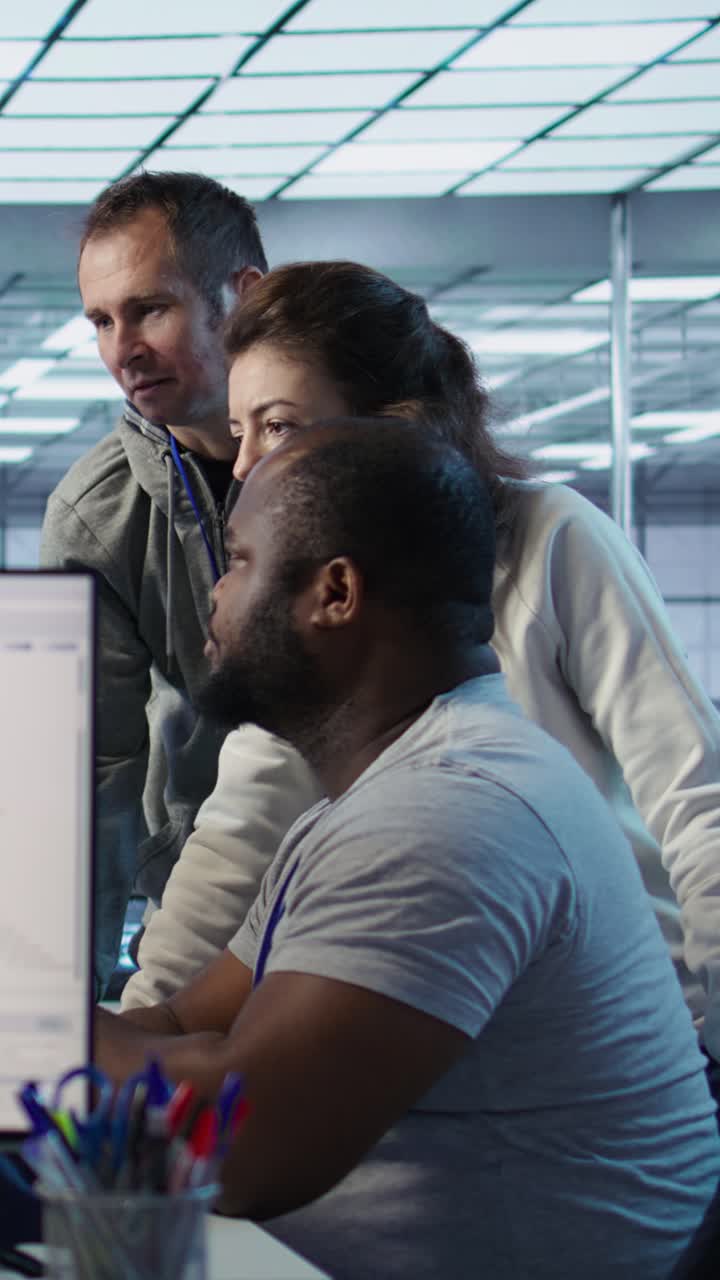 Diverse Team Collaborating on Computer in Modern Tech Office
