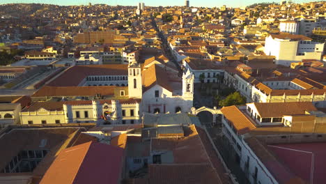 Aerial-view-over-the-historic,-colonial-architecture-of-Sucre,-Bolivia-at-sunset