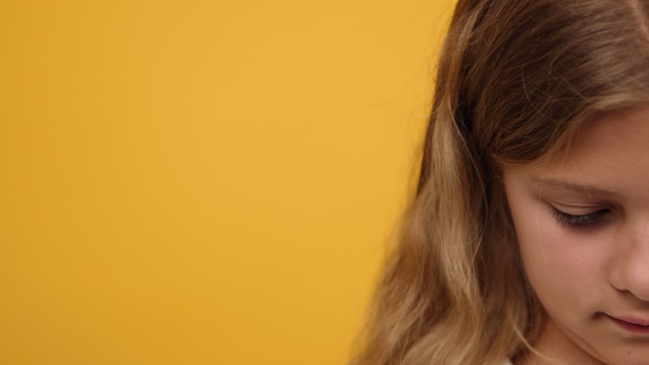 Portrait of a Smiling Girl on Yellow Background