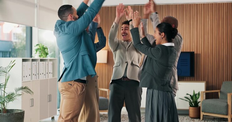 Diverse Business Team Celebrating Success with a Group Huddle