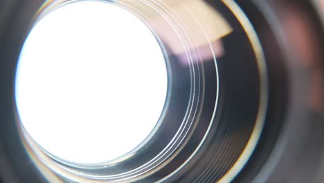 aperture blades opening and closing with white background in a de-clicked lens