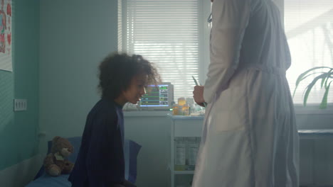 Preteen-girl-visit-doctor-in-hospital-office.-Pediatrician-talking-with-patient.