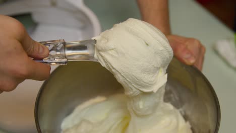 scooping ice cream in a bowl slowly