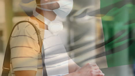 animación de la bandera de costa de marfil ondeando sobre un hombre que usa una máscara facial durante la pandemia de covid-19
