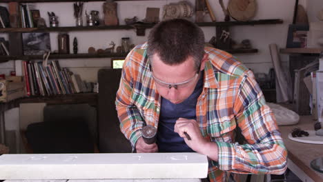 Stone-Mason-At-Work-On-Carving-In-Studio-Shot-On-RED-Camera